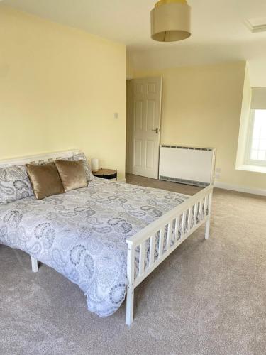 a bedroom with a large white bed in a room at Heyboys in Swansea