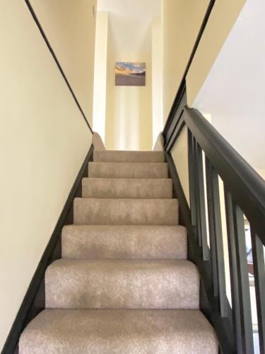 a staircase in a house with concrete stairs at Heyboys in Swansea