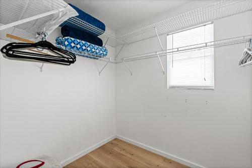a room with white walls and a window and a shelf at Private Bayfront Beach House with Dock, Steps to Beach and Restaurants in Englewood