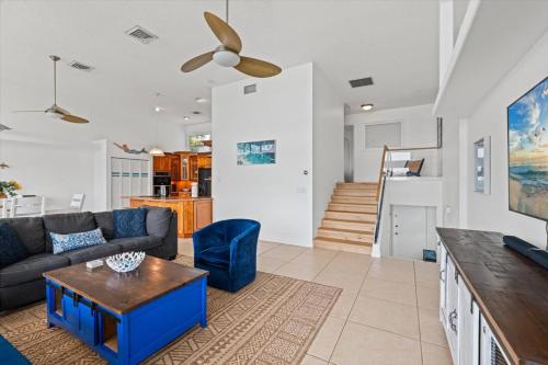 a living room with a couch and a table at Private Bayfront Beach House with Dock, Steps to Beach and Restaurants in Englewood