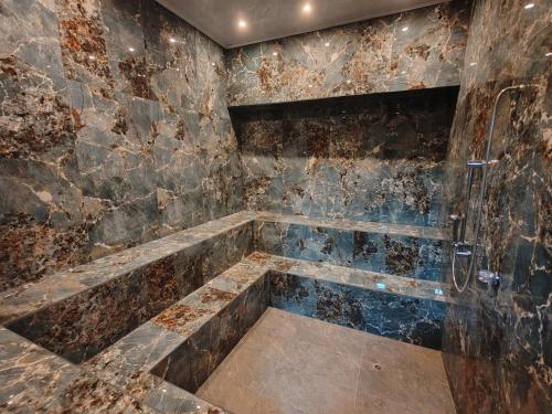 a bathroom with a tub with a shower at Herencia Hotel by Dream Vacation in Pasto