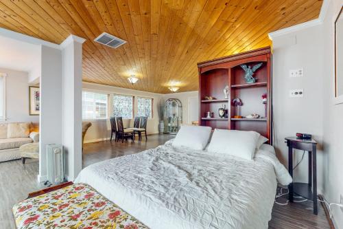 a bedroom with a large bed with a wooden ceiling at The Whole Ship in Clinton