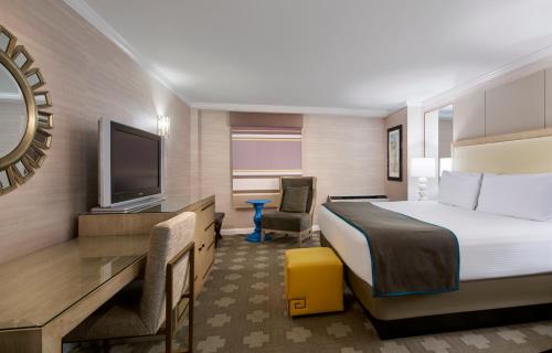 a hotel room with a bed and a flat screen tv at Caesars Atlantic City Hotel & Casino in Atlantic City