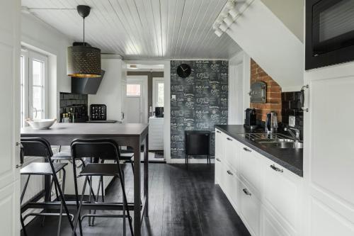 a kitchen with a table and some chairs in it at Swedish Cottage By Forest And Lake In Småland in Traryd