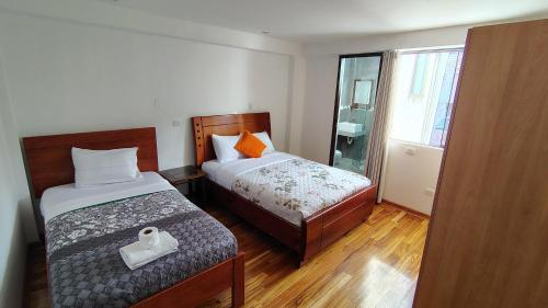 a small bedroom with a bed and a window at The Hannah's house 2 in Cusco