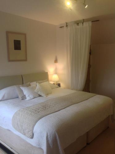 a bedroom with a large white bed with a window at Shakespeare's View in Stratford-upon-Avon