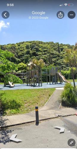 a skate park with a playground with a slide at tranquil cosy bush cabin in Lower Hutt