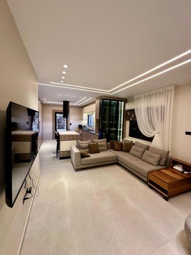 アンマンにあるModern Residence for families onlyのソファとテレビ付きの広いリビングルーム