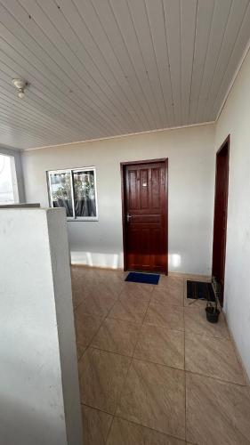 an empty room with a door and a tile floor at LUZ DO LUAR in Pedra Azul
