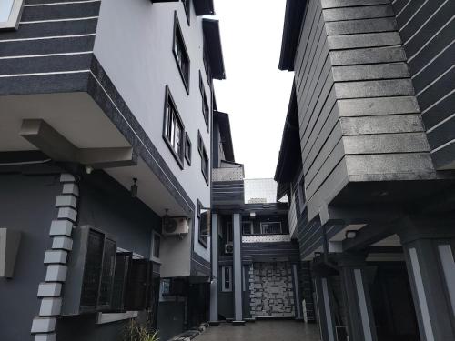 an alleyway between two buildings with stairs on the side at Caesar's Hotel & Apartment Room #4 in Ikeja