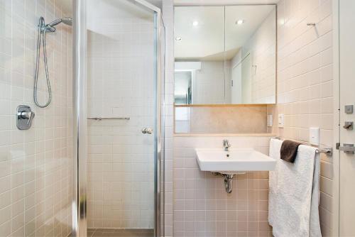a bathroom with a sink and a shower at Belle Escapes - Oceanfront Luxe at The Pier in Glenelg