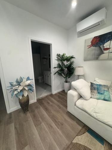 a living room with a white couch and a mirror at Stunning Guest House in West Hills California in Hughes-Canoga Park Heliport