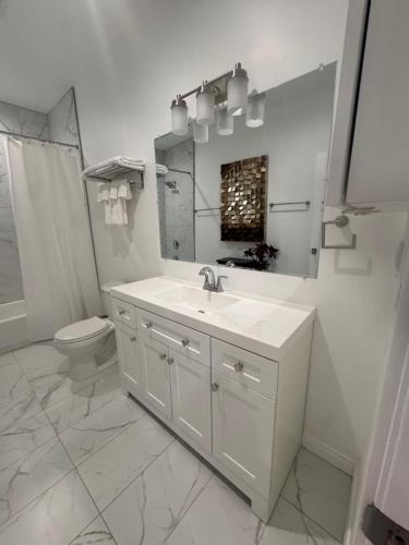 a white bathroom with a sink and a toilet at Stunning Guest House in West Hills California in Hughes-Canoga Park Heliport