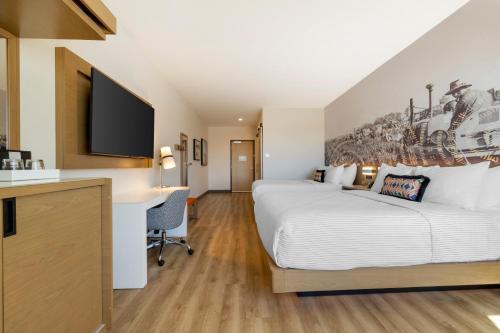 a hotel room with a bed and a desk at Cambria Hotel El Centro - Imperial in El Centro
