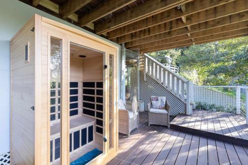 a porch of a house with a wooden deck at Cottage on Riv - Winter Holiday Mid-Week Special in Terrigal