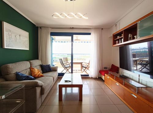 a living room with a couch and a table at Valencia Playa Patacona Resort in Valencia