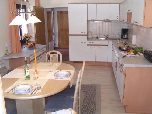 a kitchen with a wooden table with plates on it at Penzinger in Deutschlandsberg in Deutschlandsberg