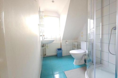 a bathroom with a toilet and a sink at Holiday apartment for 4 people in Lubin in Lubin