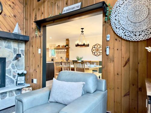 a living room with a blue couch and a fireplace at Italy Inspired Lakeview Chalet with Hot Tub in Lake Harmony