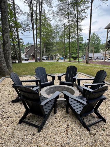 a group of chairs and a table with a fire pit at Italy Inspired Lakeview Chalet with Hot Tub in Lake Harmony