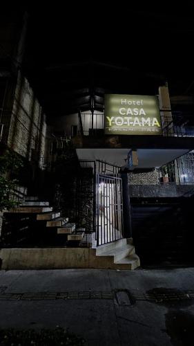メデジンにあるHotel casa yotamaの階段のある建物前の看板