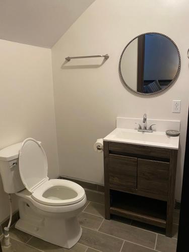 a bathroom with a toilet and a sink and a mirror at New Fully Furnished Vacation House in San Felipe