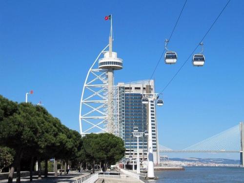 a gondola ride in front of a tall building at Relax Guest House in Lisbon