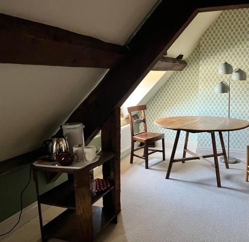 a room with a table and a table and chairs at Rooftops Loft in Hay-on-Wye