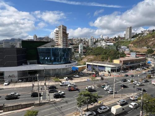 a city with cars parked in a parking lot at LK Estoril 2 in Belo Horizonte