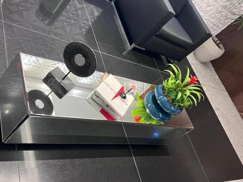 a table with a speaker and a potted plant on it at LK Estoril 2 in Belo Horizonte