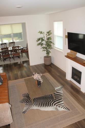 a living room with a zebra rug and a fireplace at Hot Tub Pool Table Fire Pit 5min to Uptown in Charlotte