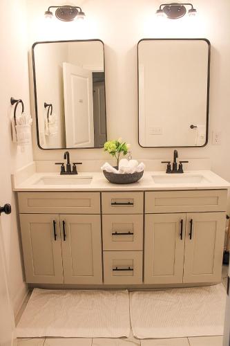 a bathroom with two sinks and a large mirror at Hot Tub Pool Table Fire Pit 5min to Uptown in Charlotte