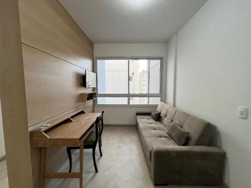 a living room with a couch and a table at LK Centro 9 in Belo Horizonte