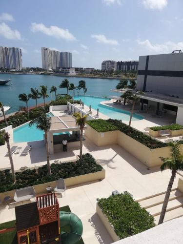 an aerial view of a resort with a body of water at Top floor, amazing sea view in Puerto Cancun in Cancún