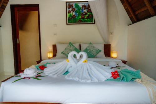 Ένα ή περισσότερα κρεβάτια σε δωμάτιο στο Kacu Bali Munduk