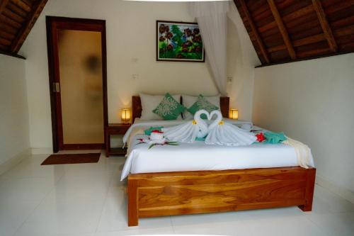 Ένα ή περισσότερα κρεβάτια σε δωμάτιο στο Kacu Bali Munduk