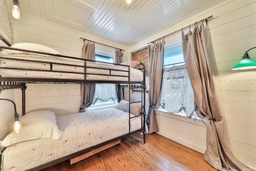 a bedroom with two bunk beds and a window at Wake Up to Waves - 3BR on the Sand in Cedar Landing