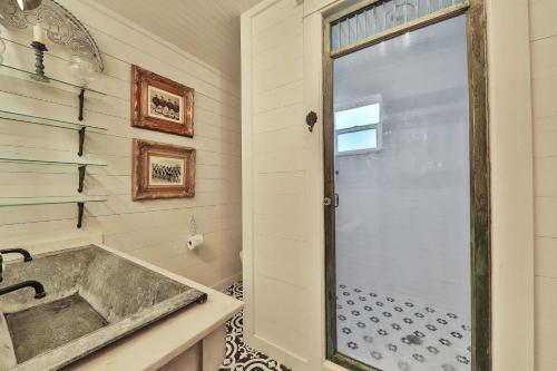 a bathroom with a sink and a shower at Wake Up to Waves - 3BR on the Sand in Cedar Landing