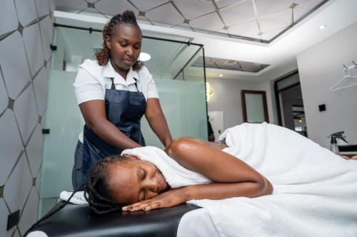 a woman in a hospital room getting her hair washed at Esiankiki Resort & Spa - Nanyuki in Nanyuki
