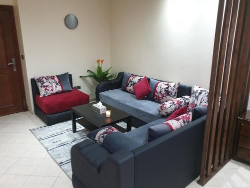 a living room with two couches and a table at Superb studio at the ocean in Rabat