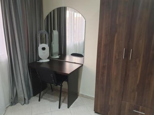a desk with a mirror next to a wooden cabinet at Superb studio at the ocean in Rabat
