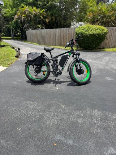 a bike parked in a driveway with green wheels at Dania Beach Unit 1 By Pmi in Dania Beach