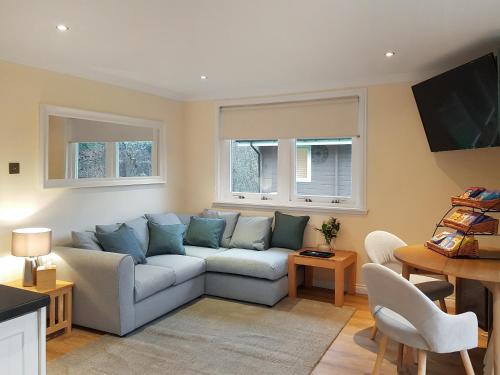 a living room with a couch and a table at Leven Lodge 1 - Uk46042 in Balloch