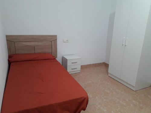 a small bedroom with a bed and a dresser at Apartamento Turístico Céntrico Galper in Melilla