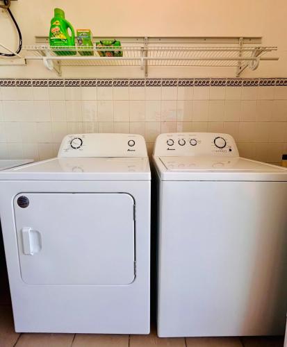 two washing machines sitting next to each other in a kitchen at Tropical Oasis! 5BR Luxe Home in Dorado
