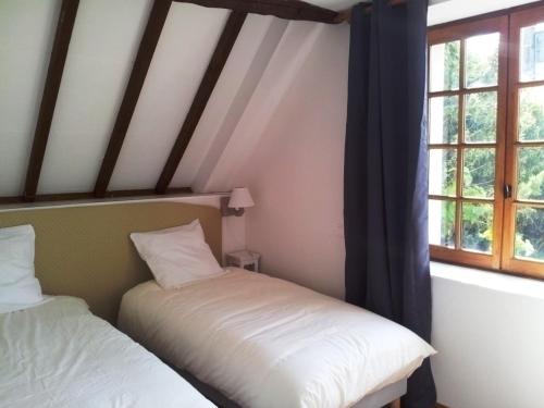 two beds in a room with two windows at Charmante grange rénovée avec vue proche de Moulins - FR-1-489-576 in Bressolles