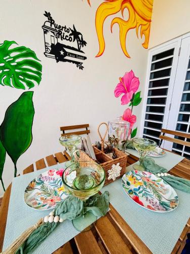 a table with plates and bowls on top of it at Tropical Oasis! 5BR Luxe Home in Dorado