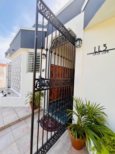 a gate in front of a house with plants at Tropical Oasis! 5BR Luxe Home in Dorado