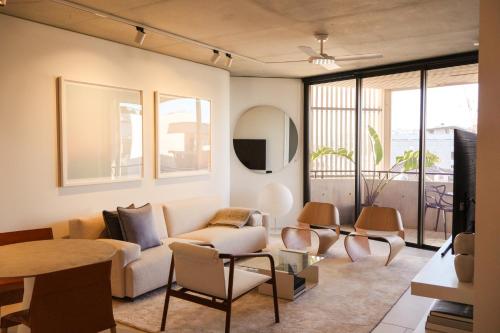 a living room with a couch and a table at Hotel Ravesis in Sydney