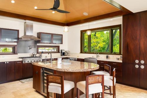 a kitchen with a large island with a counter top at Hale Waima Lani in Puako